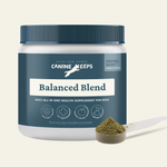 Canine Keeps supplement jar with a scoop of powder on a light background